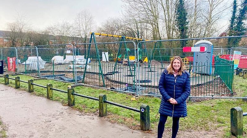 Cllr Kim Tonks standing in front of the Bratton Play Area as work on the refit progresses.