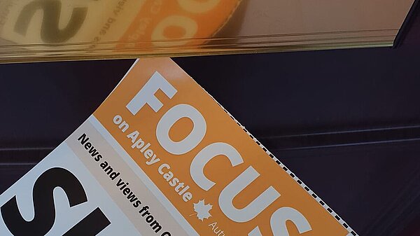 Apley Castle Focus newsletter being put through a letterbox