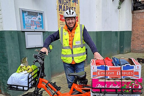 Anthony Lowe stands outside Wellington market with e-cargo bike fully loaded for a delivery shift