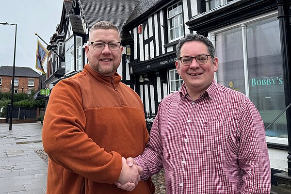 Cllr Thomas Janke and David Ellams shake hands outside Newport  Guildhall