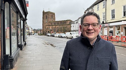 David Ellams standing in front of St Nicholas's Church on Newport High Street.